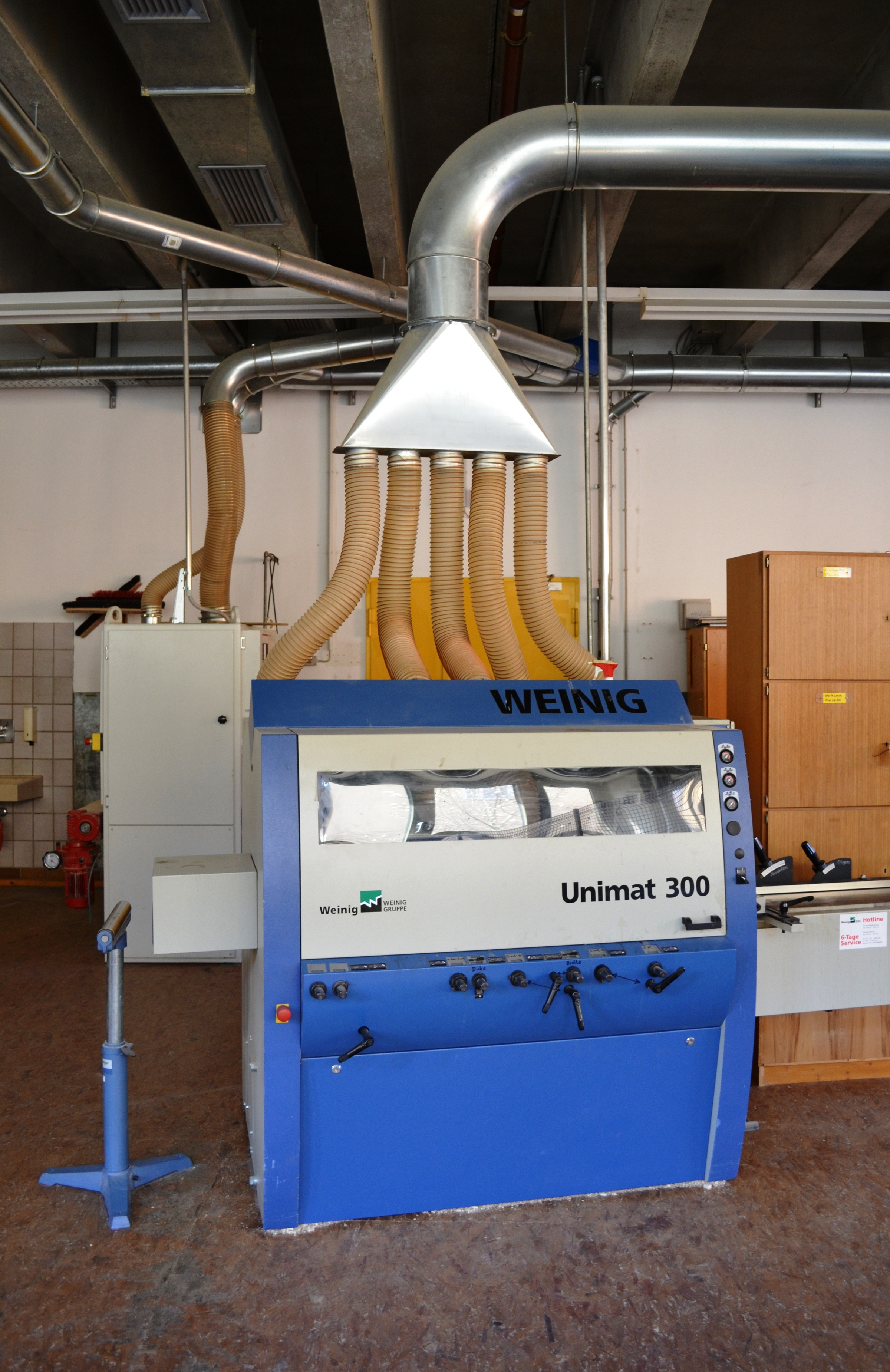 Weinig Unimat 300 industrial moulder planer showing the full cutter head housing and infeed section, a four-sided planer used in modern lumber processing
